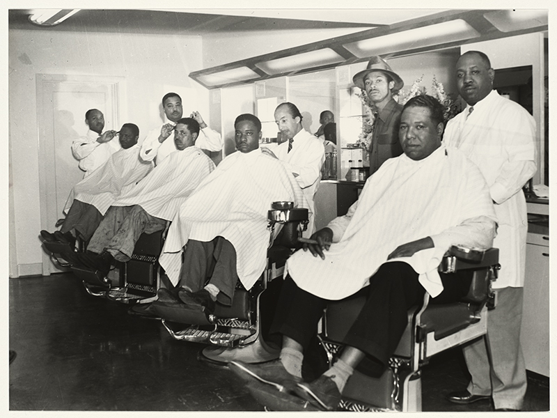 Men getting their hair cut in a barber shop