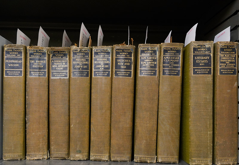 Early editions of Mark Twain’s novels line the shelves of a room in the library.