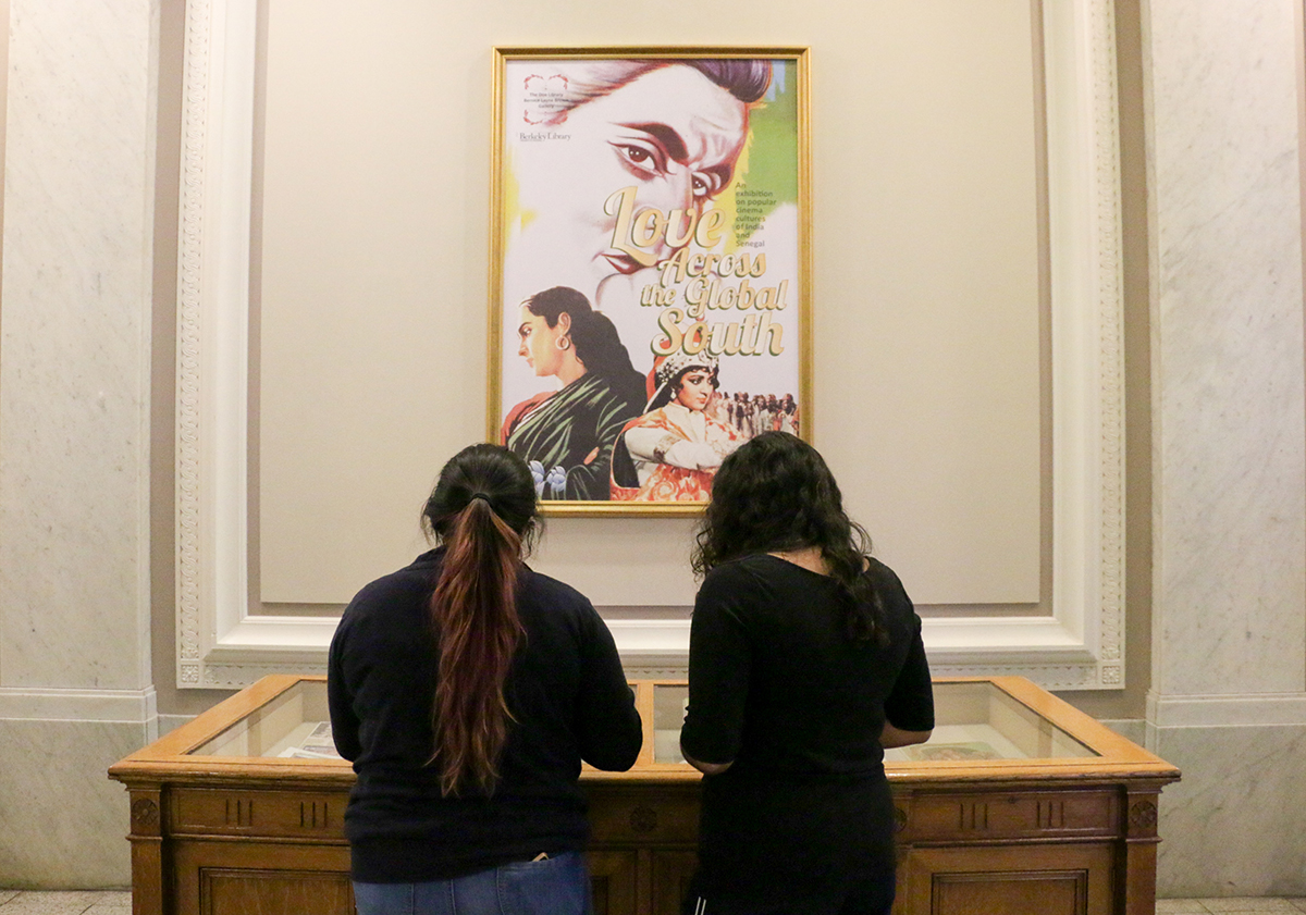 Students view the "Love Across the Global South: Popular Cinema Cultures of India and Senegal" exhibit after its opening on Oct. 6, 2017. (Photo by Cade Johnson for the University Library)